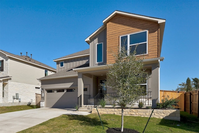 view of front of house featuring a garage and a front yard