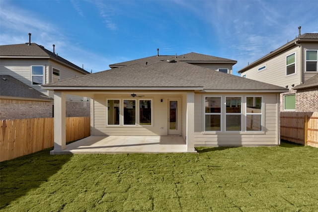 back of property featuring a lawn, ceiling fan, and a patio area