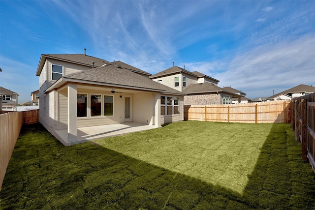 rear view of property featuring a patio and a lawn