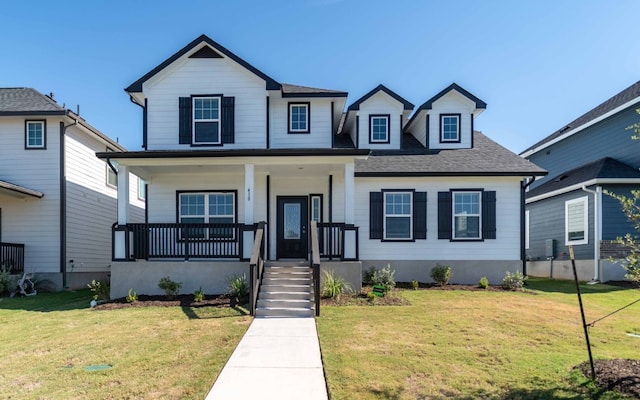 bungalow-style home with covered porch and a front yard