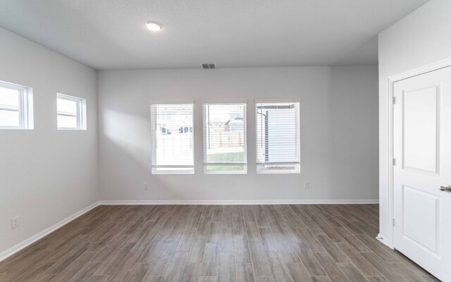 spare room with dark hardwood / wood-style floors