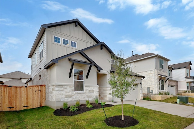 view of front of home featuring a garage, a front yard, and central air condition unit