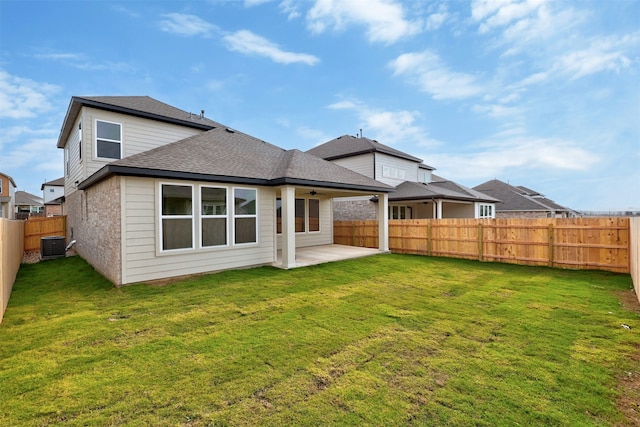 rear view of property featuring ceiling fan, a yard, a patio area, and central air condition unit