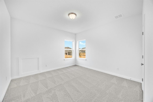 empty room featuring light colored carpet