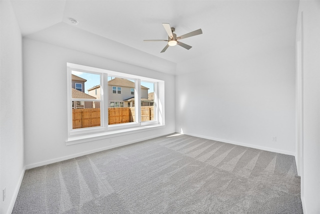 spare room with lofted ceiling, carpet flooring, and ceiling fan