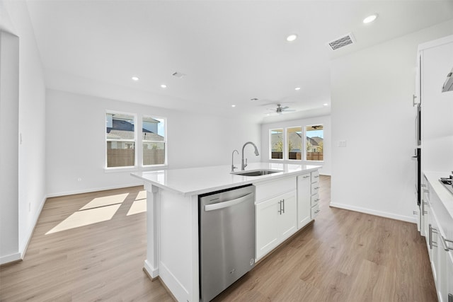 kitchen with sink, light hardwood / wood-style flooring, dishwasher, an island with sink, and white cabinets