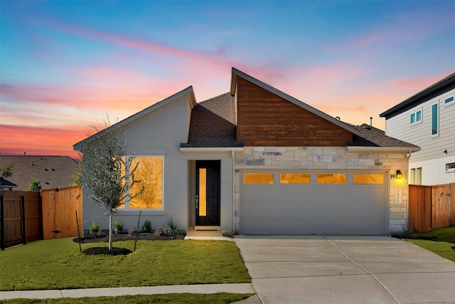 contemporary house with a garage and a lawn