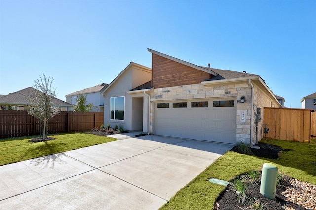 view of front of home with a garage and a front yard