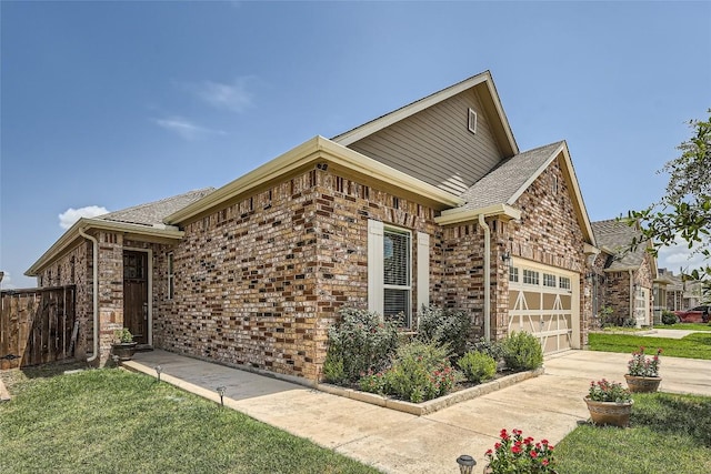 view of front of property featuring a garage and a front lawn