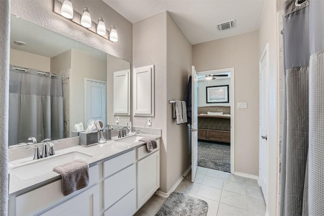 bathroom featuring tile patterned flooring, a textured ceiling, vanity, and ceiling fan