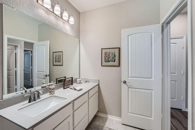 bathroom with tile patterned floors and vanity