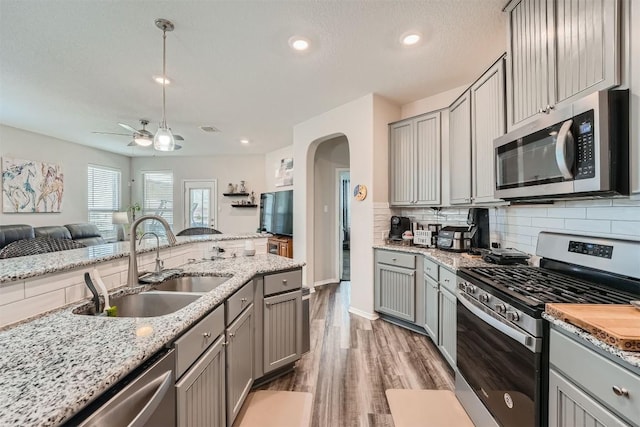 kitchen featuring gray cabinetry, sink, and stainless steel appliances