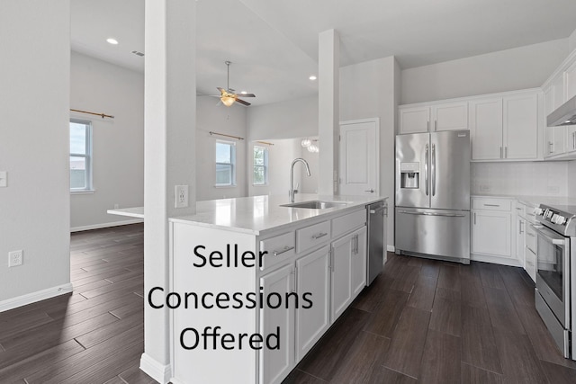 kitchen with stainless steel appliances, white cabinetry, a healthy amount of sunlight, and sink