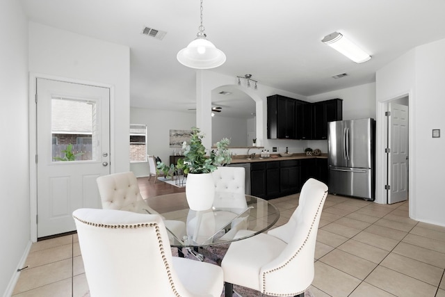 tiled dining space featuring sink and ceiling fan