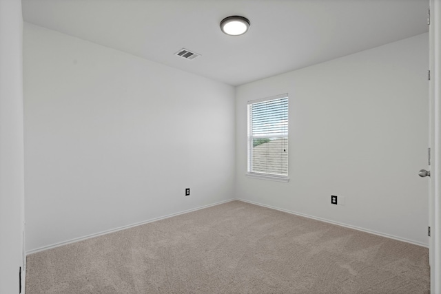 spare room featuring light colored carpet