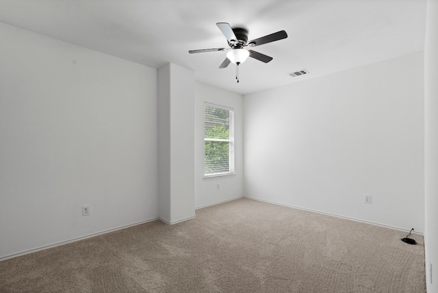 spare room featuring light colored carpet and ceiling fan