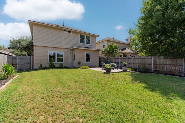 back of house with a lawn and a patio