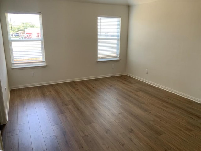 unfurnished room featuring dark hardwood / wood-style flooring