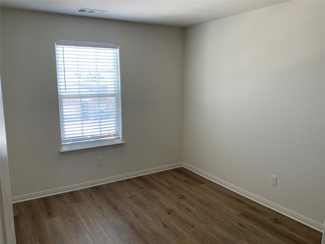 unfurnished room with dark hardwood / wood-style floors