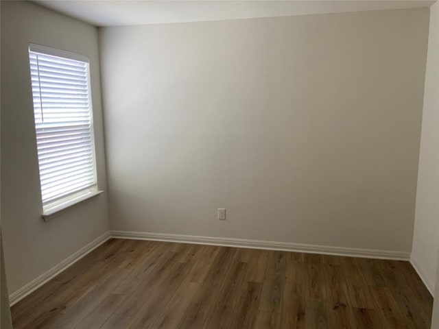 empty room with dark hardwood / wood-style floors