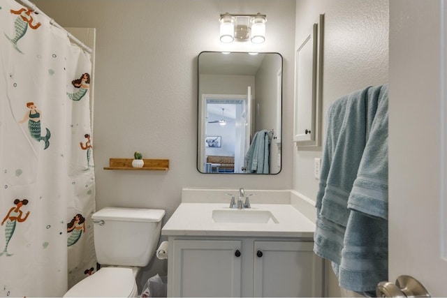 bathroom with toilet and vanity