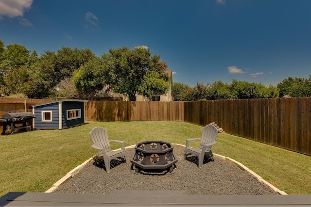 view of yard featuring an outdoor fire pit and a storage unit