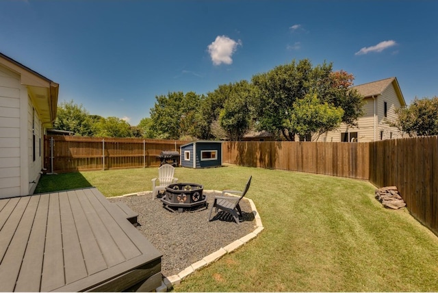 view of yard featuring a storage shed and an outdoor fire pit