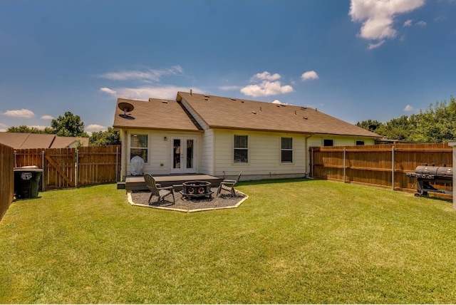 back of property featuring a patio, a yard, and french doors