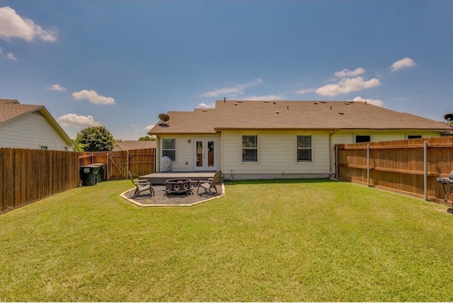 back of property with an outdoor fire pit, a patio, and a yard