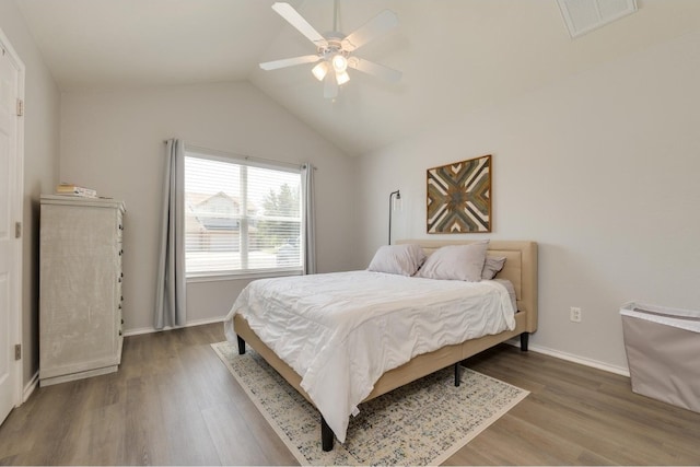 bedroom with ceiling fan, hardwood / wood-style flooring, and lofted ceiling