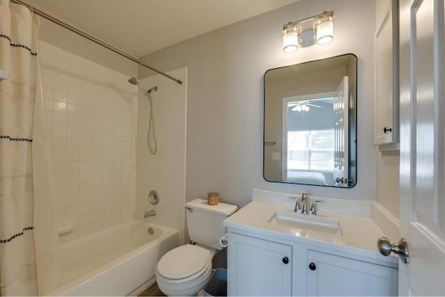 full bathroom featuring ceiling fan, vanity, shower / bathtub combination with curtain, and toilet