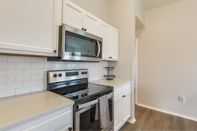 kitchen featuring backsplash, stainless steel appliances, dark hardwood / wood-style flooring, and white cabinets