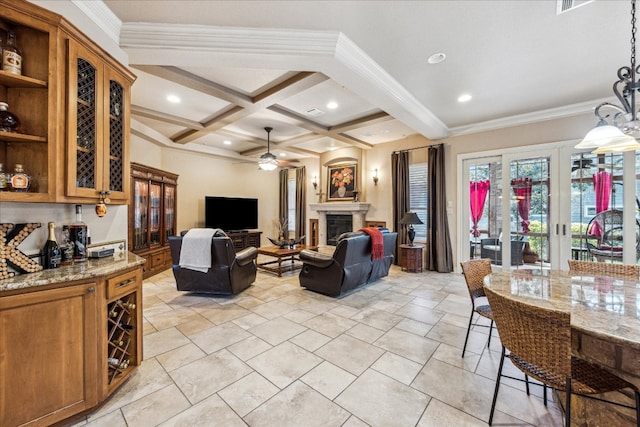 tiled living room featuring beam ceiling, ceiling fan, ornamental molding, and coffered ceiling