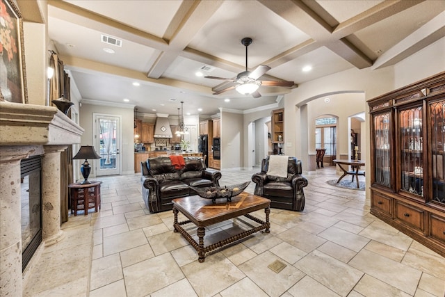 living room featuring a wealth of natural light, coffered ceiling, and ceiling fan