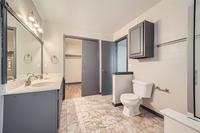 bathroom featuring wood-type flooring, vanity, and toilet