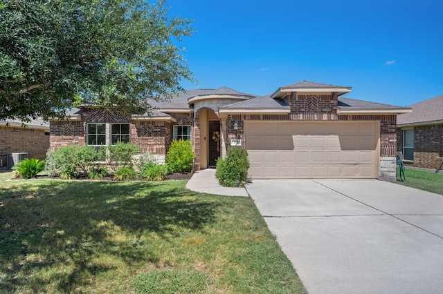 view of front of home with a front lawn, central AC unit, and a garage