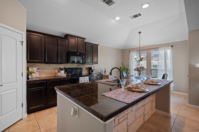 kitchen with tasteful backsplash, vaulted ceiling, black appliances, and light tile patterned flooring