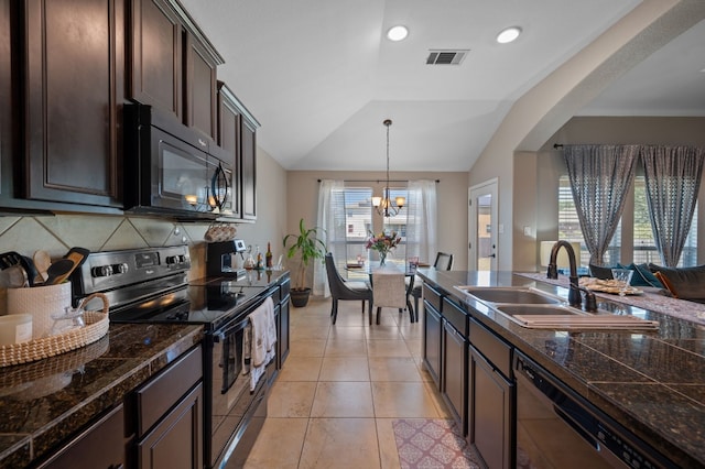 kitchen with range with electric cooktop, tasteful backsplash, vaulted ceiling, a wealth of natural light, and dark brown cabinets