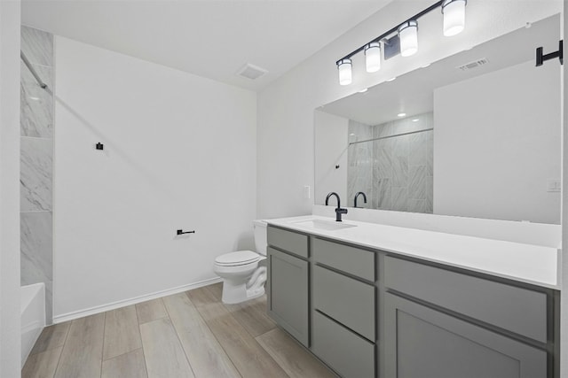 7005 Taruca Ln, Austin, TX 78736 - full bath with toilet, vanity, wood finished floors, baseboards, and a combined bath / shower with marble appearance