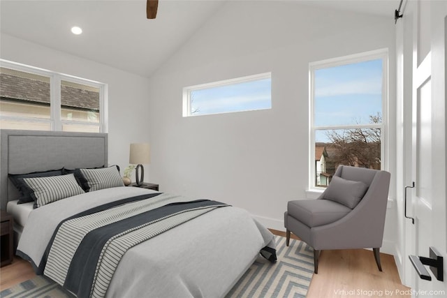 bedroom featuring light wood-style floors, recessed lighting, and vaulted ceiling