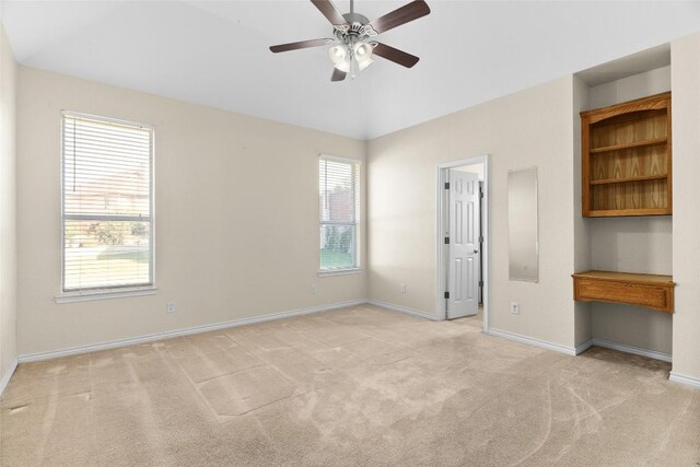 unfurnished bedroom featuring multiple windows, ceiling fan, and light colored carpet