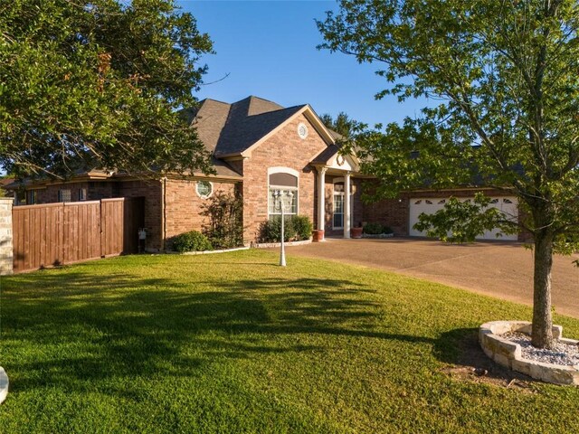 view of front of house featuring a front lawn and a garage