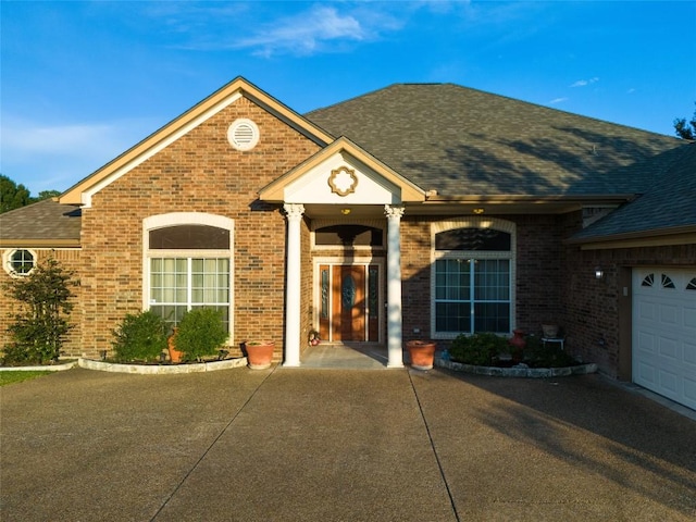 single story home featuring a shingled roof and brick siding