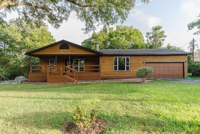 view of front facade featuring a garage, covered porch, and a front lawn