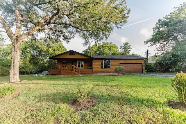 view of front of home with a garage and a front lawn