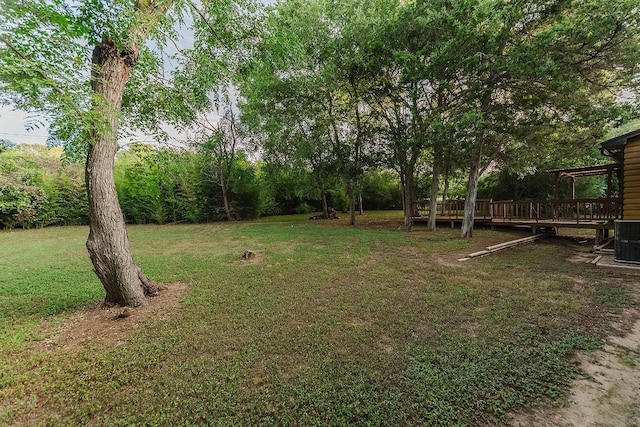 188 W Kaanapali Ln, Bastrop, TX 78602 - view of grassy yard with a wooden deck and central air condition unit