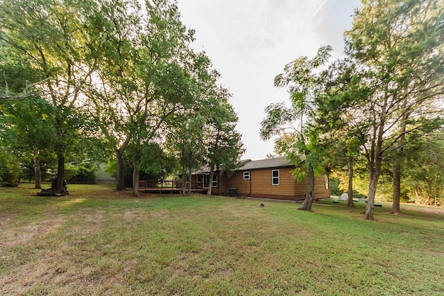 188 W Kaanapali Ln, Bastrop, TX 78602 - view of green lawn with a wooden deck