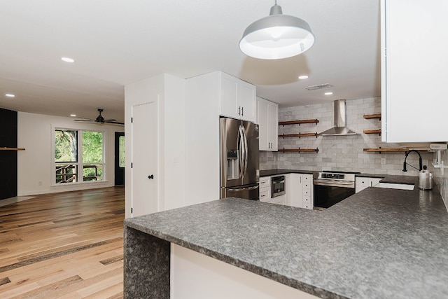 kitchen with oven, wall chimney exhaust hood, pendant lighting, stainless steel fridge with ice dispenser, and tasteful backsplash