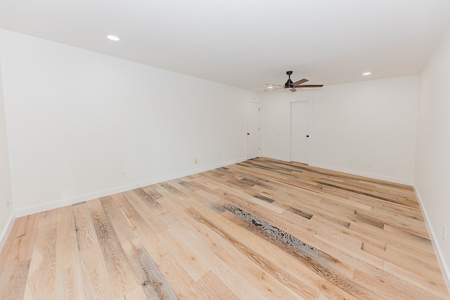 spare room featuring ceiling fan and light wood-type flooring