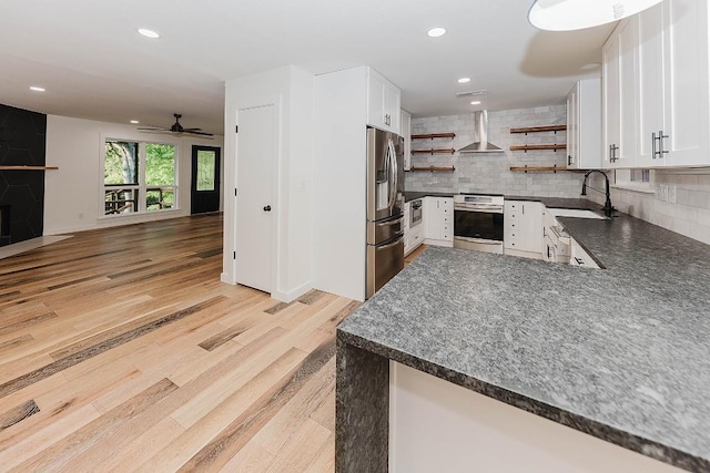 188 W Kaanapali Ln, Bastrop, TX 78602 - kitchen with wall chimney exhaust hood, appliances with stainless steel finishes, open shelves, a sink, and dark countertops